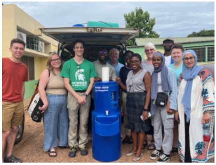 A group photo in front on a clean water fountain