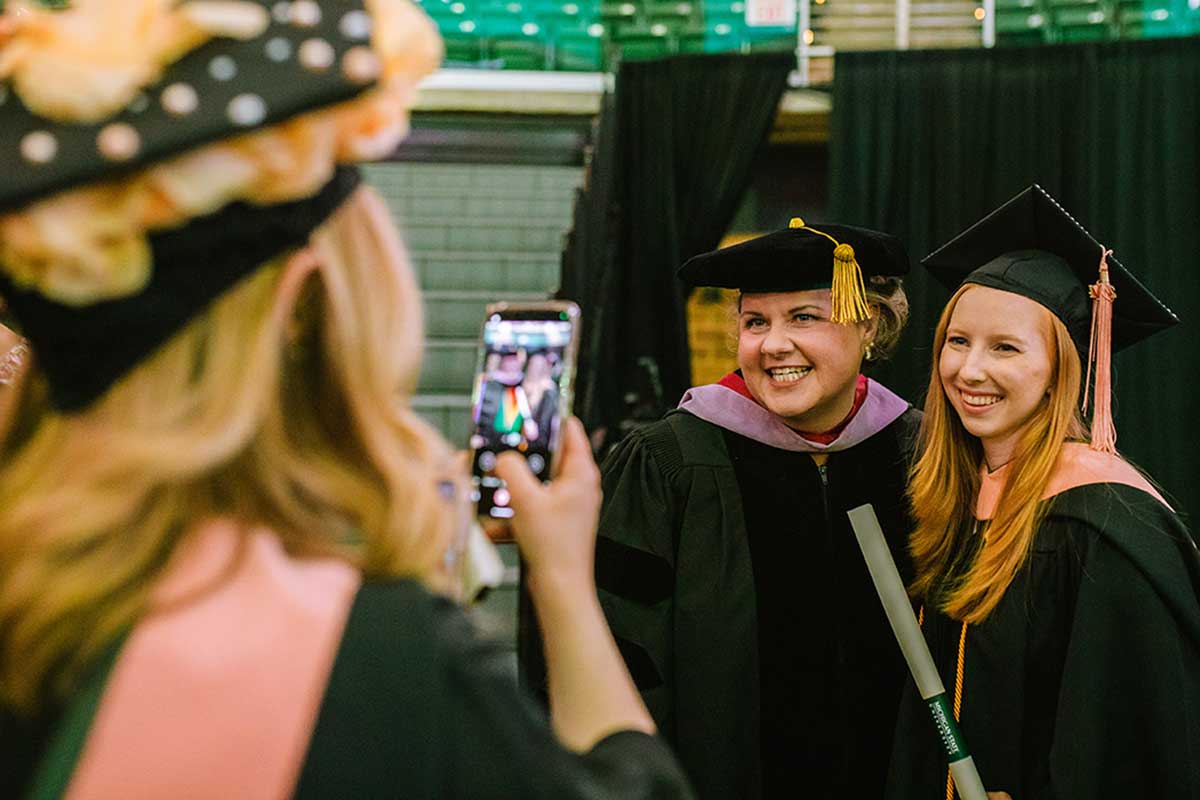 Graduates with faculty posing for photo