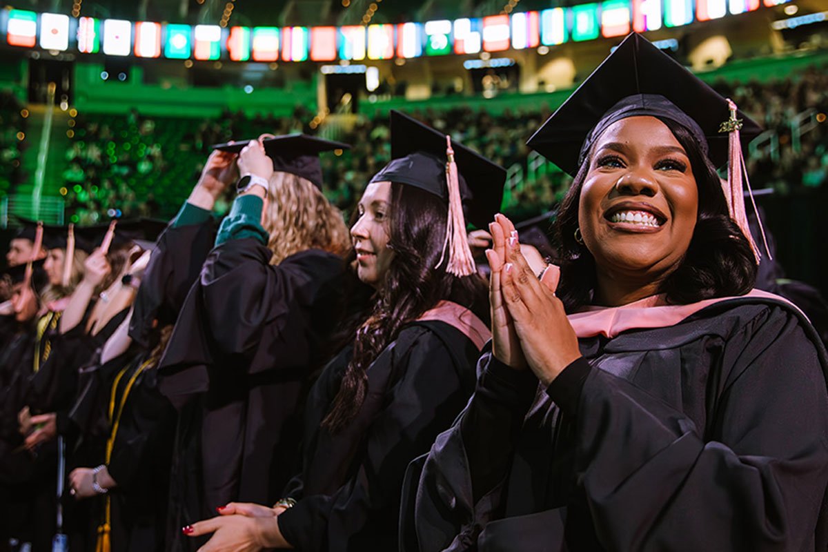 Fall 2025 Graduates smiling and clapping